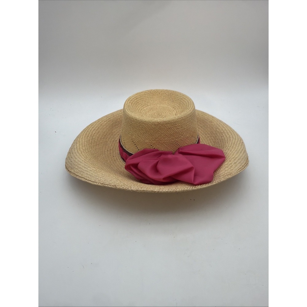 natural woven straw sun hat accented with a vibrant fuchsia